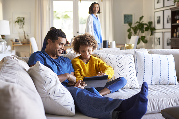 father sitting on sofa