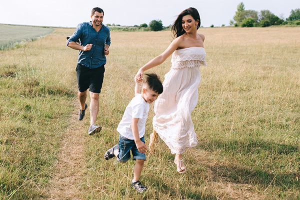 happy parents and son running 2516